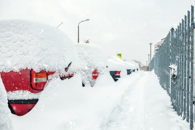 Commercial snowplow clearing accumulated snow for an Aurora-area commercial property